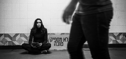 אשה יושבת עם שלט לא מספיק טובה